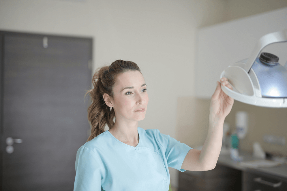 Veterinary nurse adjusting a surgical lamp